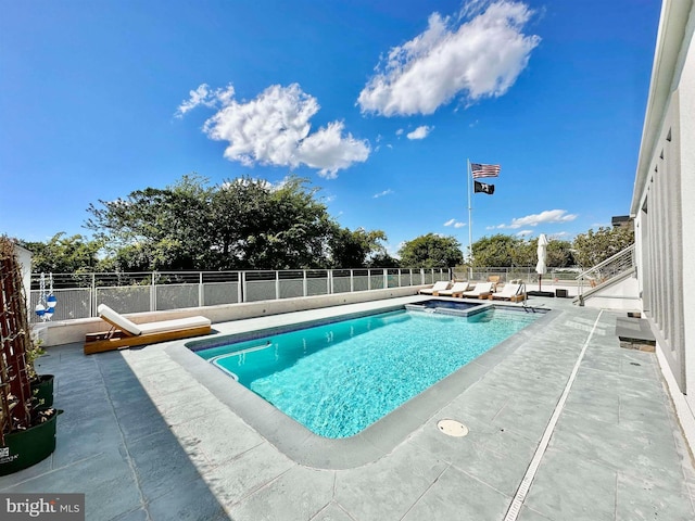 view of pool with a fenced backyard, a patio area, and a pool with connected hot tub