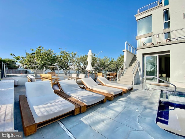 view of patio featuring stairway and outdoor dining space