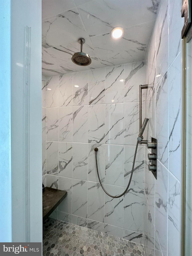 full bath with a marble finish shower