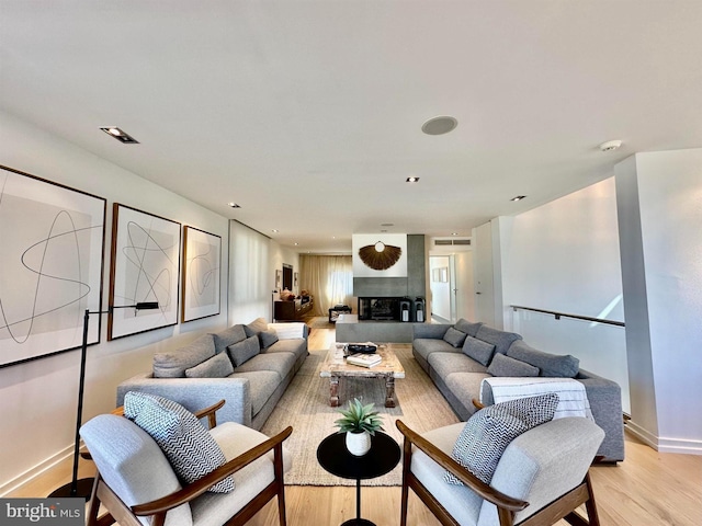 living area with baseboards and light wood-style flooring