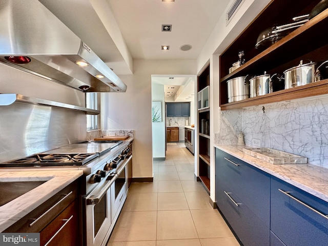 kitchen featuring wall chimney range hood, open shelves, decorative backsplash, double oven range, and light tile patterned floors