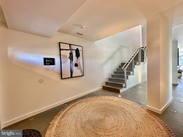 stairs with baseboards and visible vents