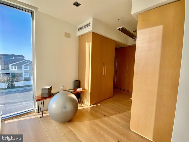 interior space with visible vents and wood finished floors