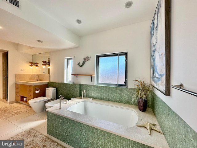 bathroom with tile patterned flooring, vanity, toilet, visible vents, and a garden tub