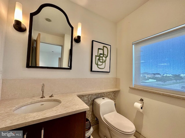 bathroom with toilet and vanity
