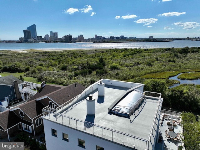 birds eye view of property featuring a view of city and a water view