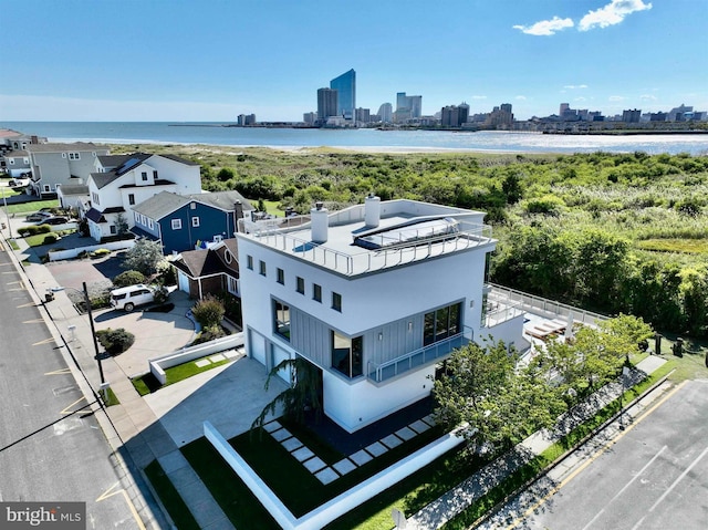 birds eye view of property with a city view and a water view