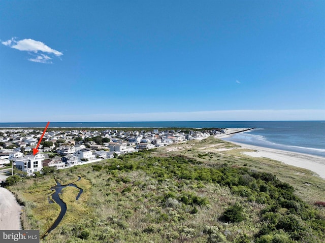 drone / aerial view featuring a view of the beach and a water view