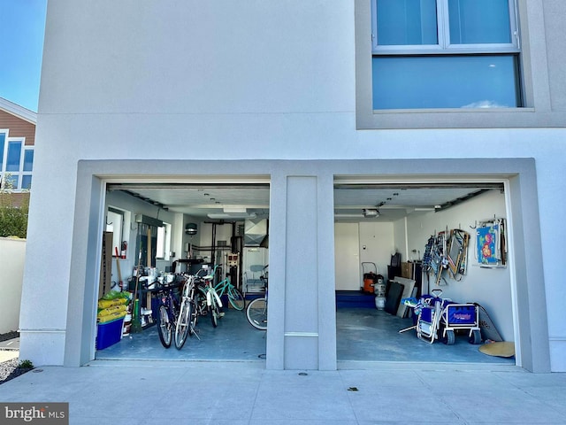 garage featuring concrete driveway
