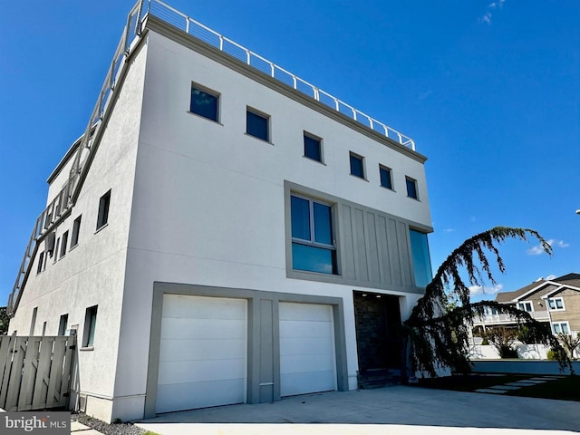 exterior space featuring an attached garage, stucco siding, and driveway
