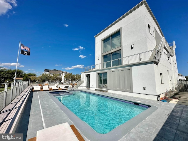 view of pool featuring fence, a fenced in pool, stairs, and a patio area