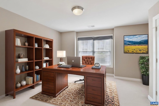 home office with visible vents, baseboards, and light colored carpet
