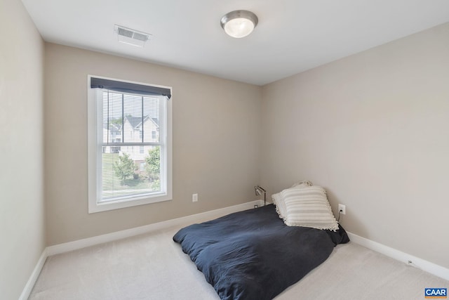bedroom featuring visible vents, carpet, and baseboards