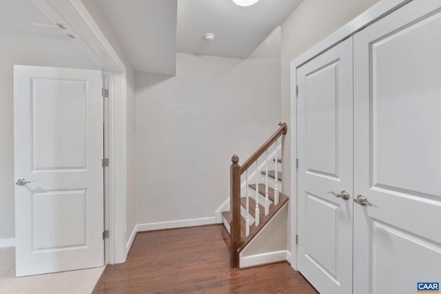 hall featuring baseboards and wood finished floors