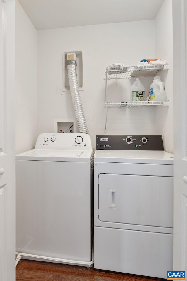 laundry area featuring washer and dryer, laundry area, and wood finished floors