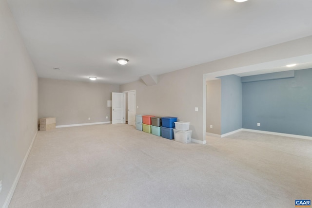 finished basement featuring baseboards and carpet flooring