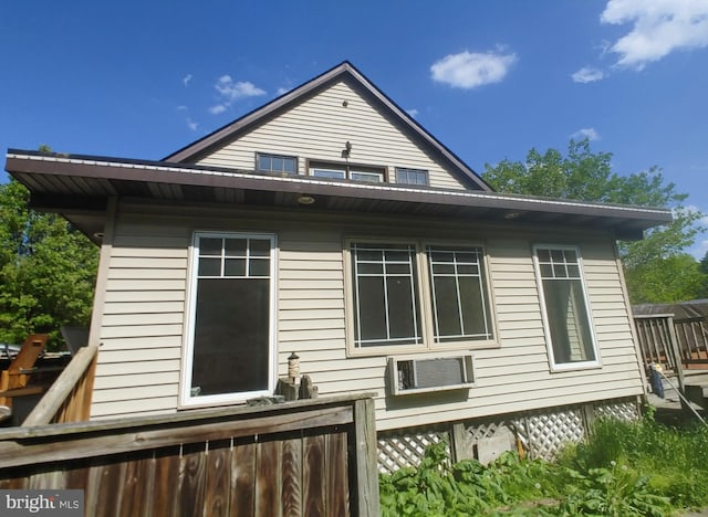 view of side of home featuring a wall unit AC