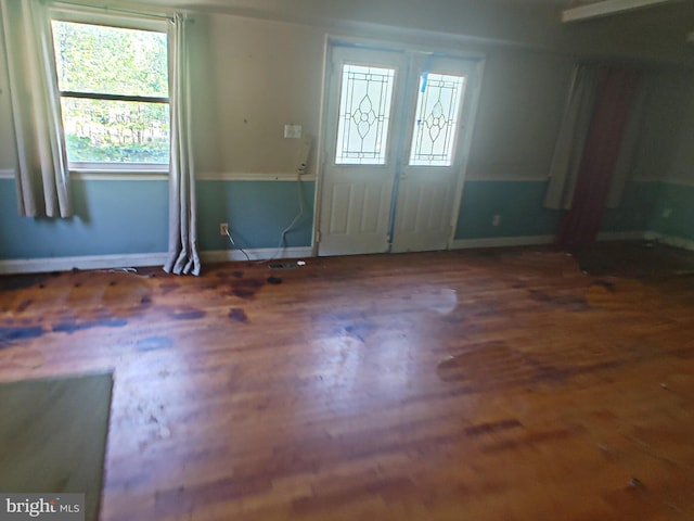 entrance foyer with baseboards and wood finished floors