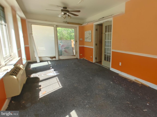 interior space featuring a ceiling fan and baseboards