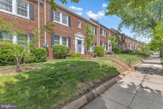 945 Randolph St NW Unit A, Washington, DC 20011 - view of front of house featuring brick siding, a residential view, and a front yard