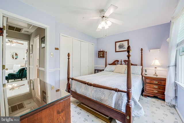 carpeted bedroom with ceiling fan, a closet, and visible vents