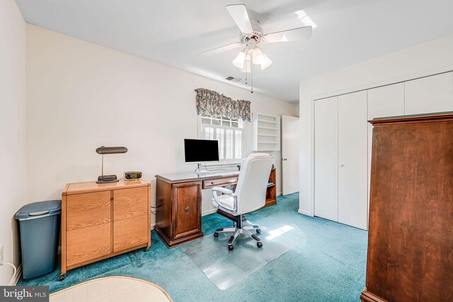 home office with visible vents, carpet flooring, and ceiling fan