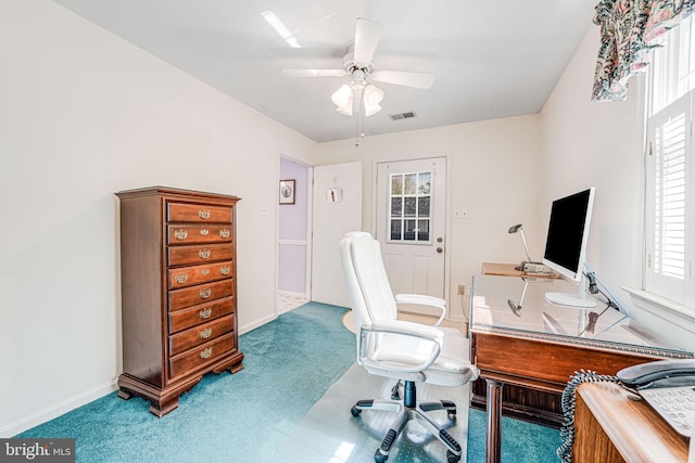 carpeted office space featuring baseboards, a ceiling fan, and visible vents