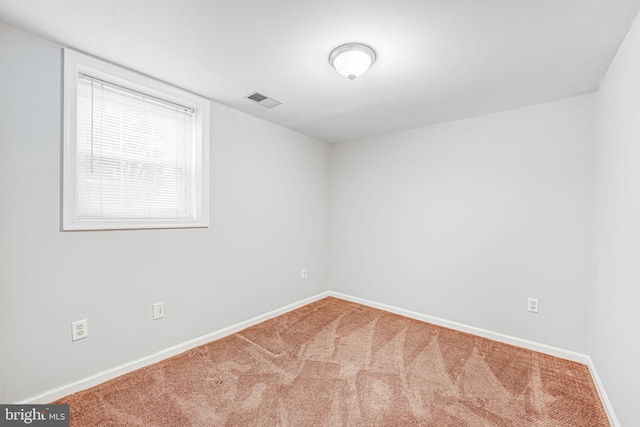 unfurnished room with visible vents, carpet, and baseboards