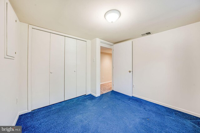 unfurnished bedroom with visible vents, carpet, baseboards, and a closet