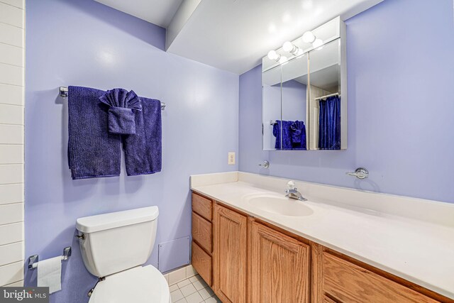 bathroom with vanity, tile patterned floors, and toilet