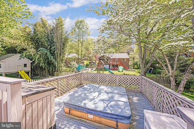 wooden deck with a covered hot tub