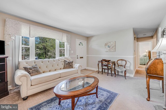 carpeted living area featuring baseboards