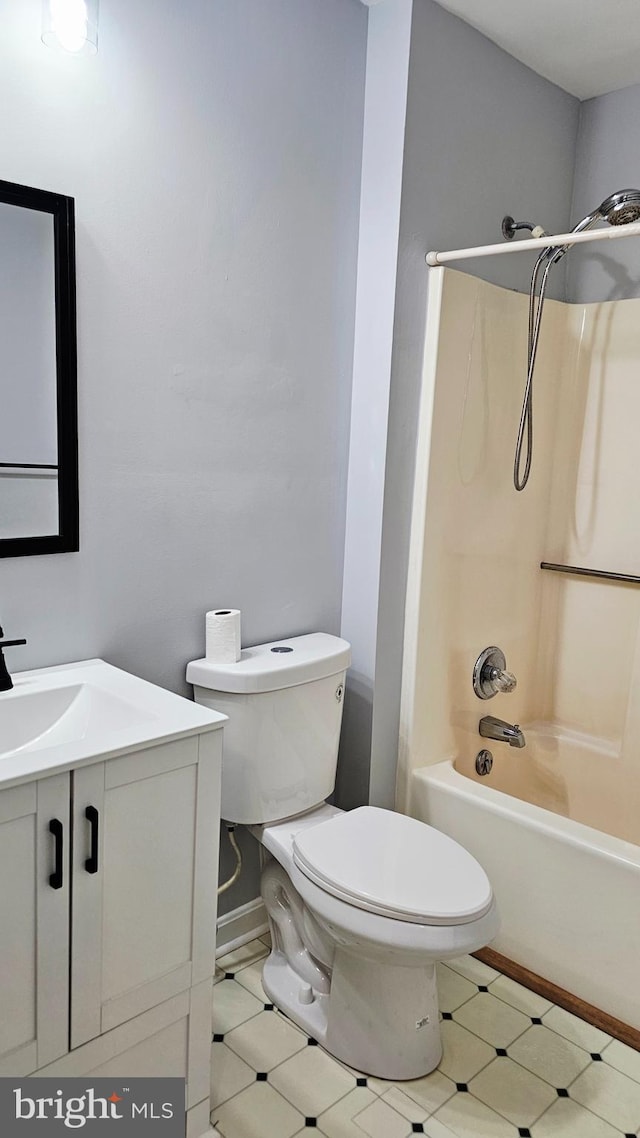 bathroom featuring vanity, shower / bathtub combination, and toilet