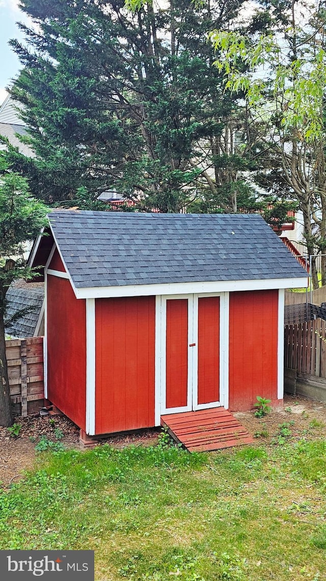view of shed featuring fence