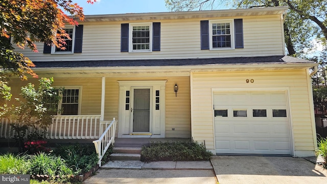 view of front of home with a garage, covered porch, and concrete driveway