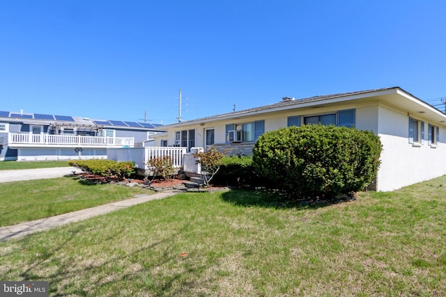 1306 Bayshore Ave, Brigantine, NJ 08203 - view of front of home featuring a front yard and stucco siding