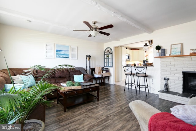 1306 Bayshore Ave, Brigantine, NJ 08203 - living room with a fireplace, beamed ceiling, a ceiling fan, and dark wood-style flooring