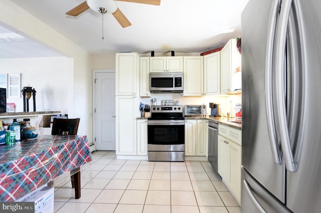 1306 Bayshore Ave, Brigantine, NJ 08203 - kitchen featuring ceiling fan, stainless steel appliances, cream cabinetry, light tile patterned floors, and a toaster