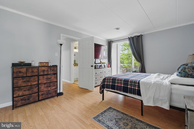 bedroom featuring baseboards and light wood-style flooring