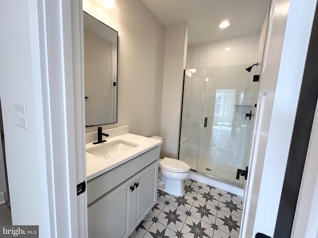 full bath with recessed lighting, vanity, a shower stall, and toilet