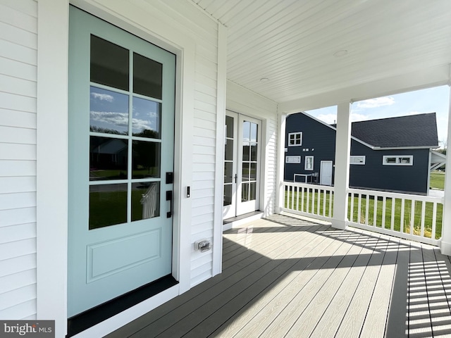 deck featuring a porch and french doors