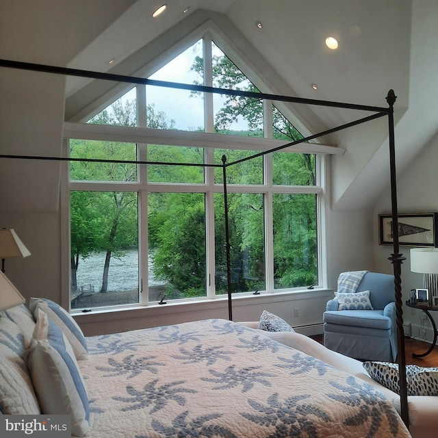 bedroom with a water view, a baseboard heating unit, recessed lighting, vaulted ceiling, and wood finished floors