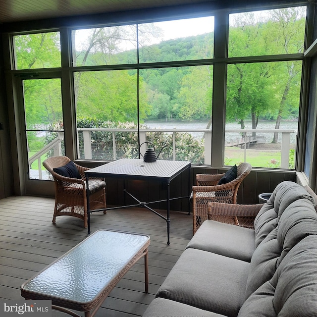 sunroom / solarium featuring healthy amount of natural light