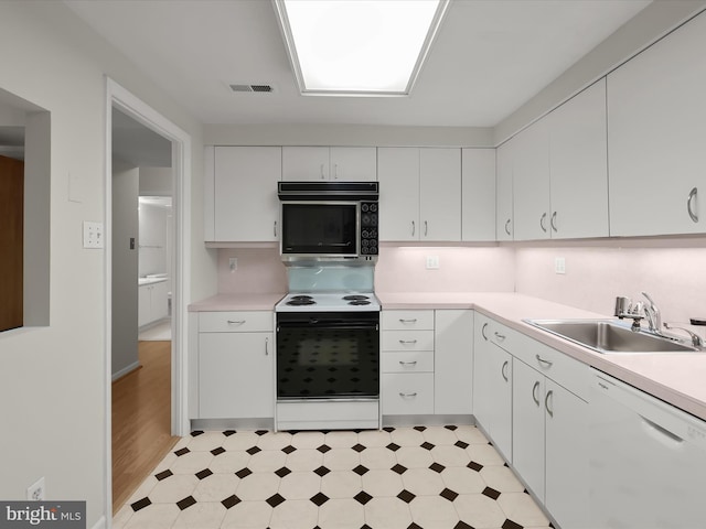 6317 Park Heights Ave Unit 221, Baltimore, MD 21215 - kitchen with electric range oven, a sink, dishwasher, light flooring, and light countertops