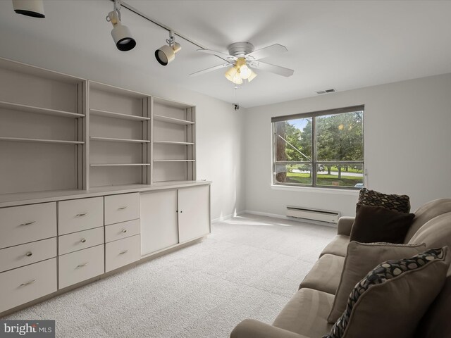 6317 Park Heights Ave Unit 221, Baltimore, MD 21215 - living area featuring a baseboard heating unit, light carpet, a ceiling fan, and baseboards