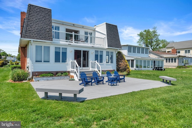 4249 Kings Rd, Edgewater, MD 21037 - rear view of property featuring a balcony, a shingled roof, a lawn, and a wooden deck