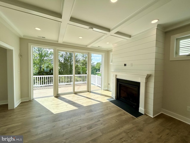 unfurnished living room with baseboards, a fireplace with flush hearth, beam ceiling, and coffered ceiling