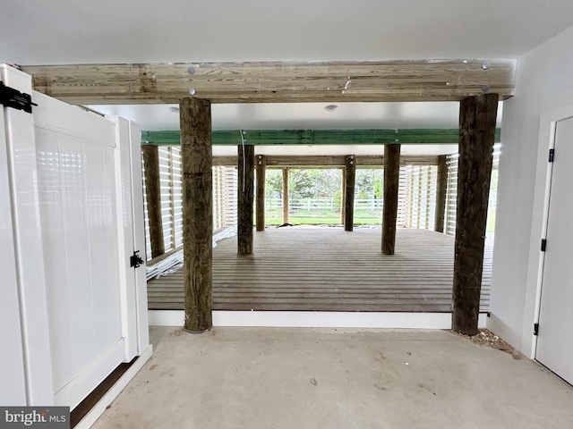 exterior space with baseboards and concrete floors