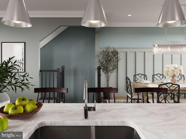 interior details with recessed lighting, ornamental molding, a sink, and a notable chandelier
