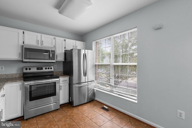 2204 Commissary Cir, Odenton, MD 21113 - kitchen with stainless steel appliances, white cabinetry, light tile patterned flooring, and light stone countertops